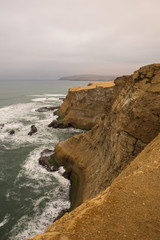 Dramatic coastline with intense colors in the desert of Paracas National Reserve, Peru