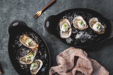 Raw oyster with mignonette sauce, celery & cream in cast iron on ice