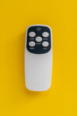 simple remote wireless controlle on color background isolated top view
