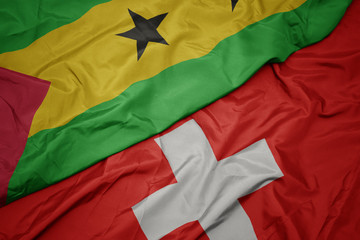 waving colorful flag of switzerland and national flag of sao tome and principe .