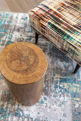 Fototapeta na wymiar Upholstered Chair and Wooden Log End Table