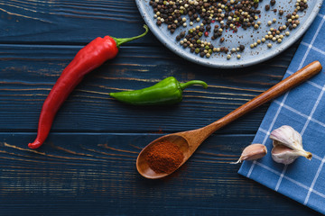 Garlic pepper paprika on a wooden spoon and spices © Atrom