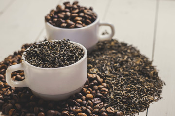 Yin-yang composition with coffee and tea on wooden table