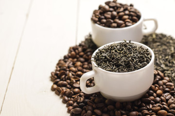 Yin-yang composition with coffee and tea on wooden table