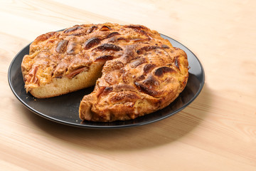 Charlotte pie on the wooden table