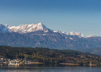 Austrian landscape with snowy mountains and clear waters lake