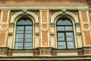 antique wooden frame with transparent glass on the facade of the building with a textured bas-relief