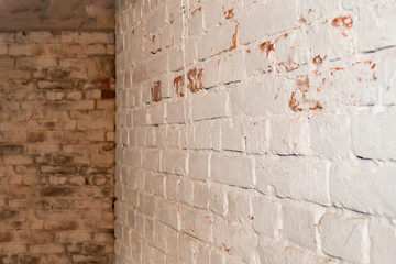Fragment of an old brick wall in the basement