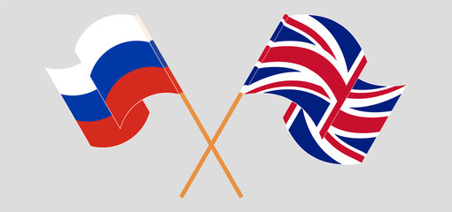 Crossed and waving flags of the UK and Russia