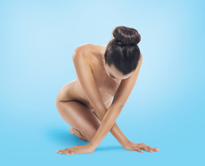 Obraz premium Naked beauty girl poses on blue background