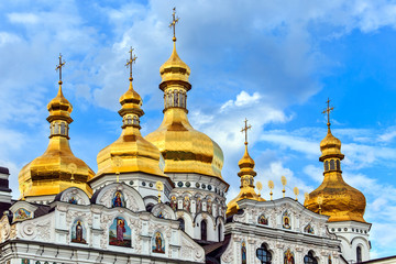 Fototapeta na wymiar Golden cupolas with crosses of the The Cathedral of the Assumption of the blessed virgin Mary in Kiev Pechersk Lavra Orthodox monastery, Kiev, Ukraine.