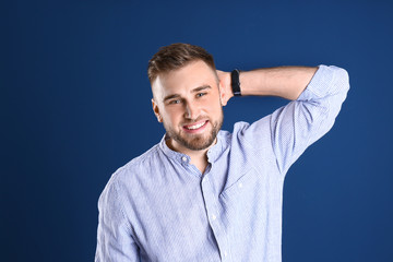 Portrait of handsome happy man on color background
