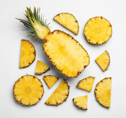 Composition with raw cut pineapple on white background, top view
