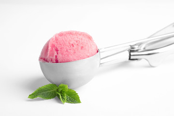 Scoop with delicious ice cream and mint on white background