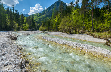 Beautiful landscape scene with forest, mountains and river in Slovenia, Europe.