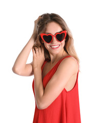 Naklejka premium Young beautiful woman wearing heart shaped glasses on white background