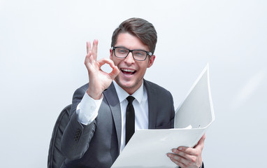 close up. businessman with clipboard showing OK gesture