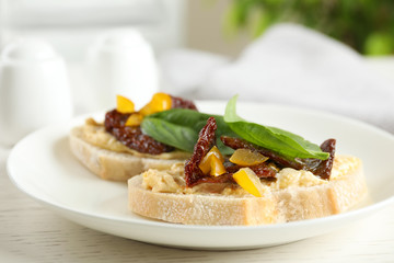 Plate of delicious tomato bruschettas on table, closeup