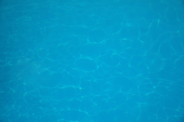 Surface of swimming pool with clean blue water as background
