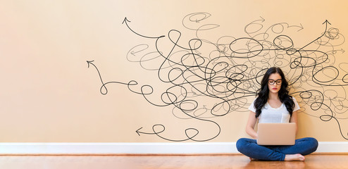 Solving a problem concept with young woman using a laptop computer