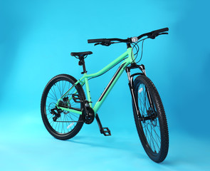 Fototapeta premium Modern bicycle on blue background. Healthy lifestyle