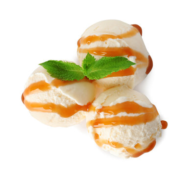 Scoops of delicious ice cream with mint and caramel sauce on white background, top view