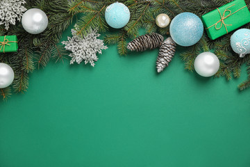 Fir branches with Christmas decoration on green background, flat lay. Space for text