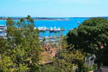 The city of Cannes in France, the famous Promenade de la Croisette and marina with yachts