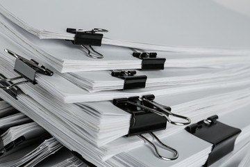 Pile of documents with binder clips, closeup