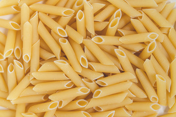 uncooked pasta penne in natural light