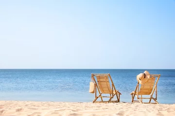Fototapeten Wooden deck chairs on sandy beach near sea © New Africa
