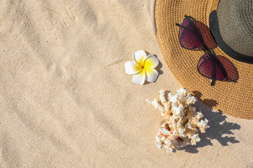 Flat lay composition with different beach accessories on sand. Space for text