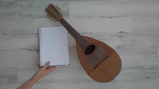 Composer taking notes, and uke to go write a song. white background, 4k flat lay