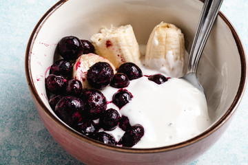 Yogurt with banana, blueberries and chocolate ready to eat in a bowl