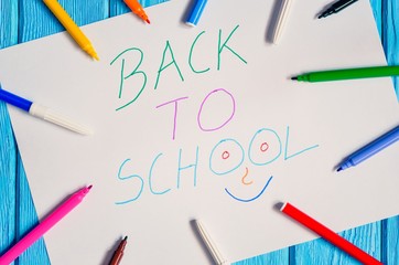 Creative idea depicting the return of children to school. School markers and a card with the text back to school.