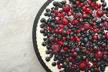 Berry pie with fresh berries and cream on murble table with cherry, currant, blackberry, blueberry. Cheesecake, top view, close up with copy space.