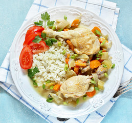 keto dish. Chicken with Cauliflower Rice. low carbohydrates a lot of protein. stewed chicken with celery and carrots in a white plate. top view. copy space.