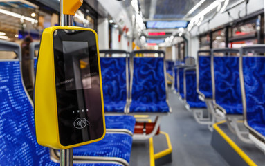 Modern touch payment terminal in bus. Terminal of payment for travel by transport or bank cards....