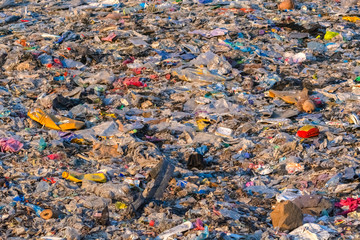 garbage dump with lot of plastic bag and bottles and other waste