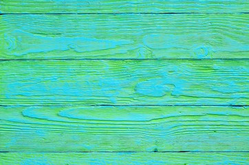 Wooden background texture. Creatively painted green and blue boards.