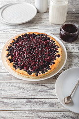 Berry pie with cherry, currant, blackberry, blueberry on served white wooden table . Cheesecake.