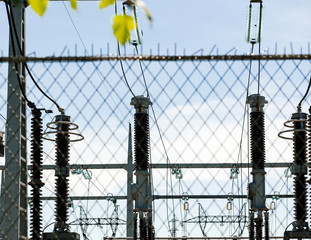 View through security fence of high voltage French power lines hydroelectric power plant at Centrale Hydroelectrique de Gambsheim in the background