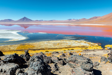 Complete wide angle landscape of the red lagoon (laguna colorada) with all its colors due to algae and sediments in the region of the Uyuni Salt Flat in Bolivia, South America. © SL-Photography