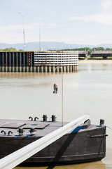 Front part of old tanker barge cargo ship on Rhine River with owl lucky statue on the front