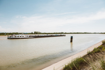 Wide image of large barge cargo boat on the Rhine River transporting goods