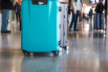 Traveler walking alone with suitcase bag in the airport.