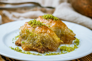 baklava sobiet with pistachios on wooden table. Turkish cuisine