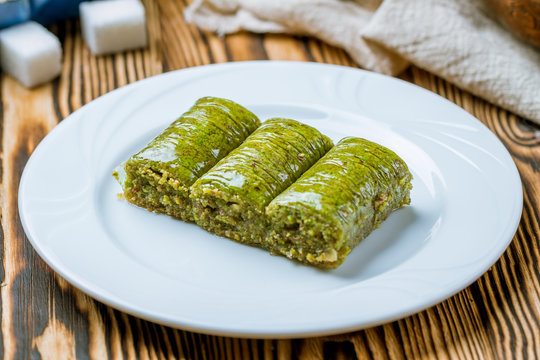 Sarma with pistachios on wooden table. Turkish cuisine.