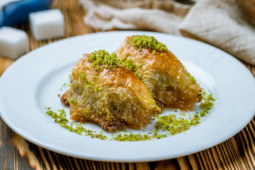 baklava sobiet with pistachios on wooden table. Turkish cuisine