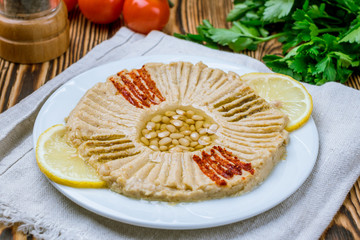 Traditional homemade hummus on wooden table. Turkish cuisine.